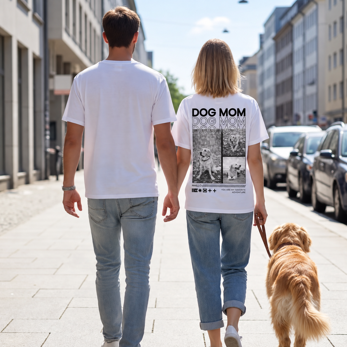 Due persone camminano mano nella mano per strada, la donna indossa una T-shirt con la scritta "DOG MOM".