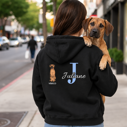 Felpa con cappuccio nera con iniziale personalizzata "J" e motivo di cane sul retro. Indossata da una persona con un cane.