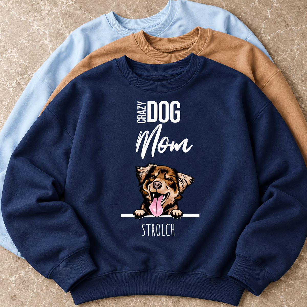 Tre felpe blu, marrone e blu scuro con motivo di cane e la scritta "Crazy Dog Mom".