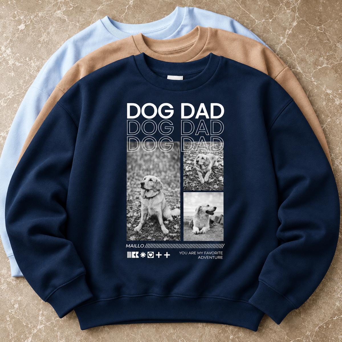 Tre felpe di colori diversi, una blu navy con grafica Dog Dad e foto di cani.