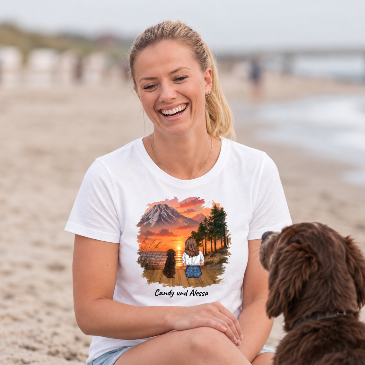 T-shirt bianca con stampa personalizzata di un paesaggio con cane, la donna ride in spiaggia.