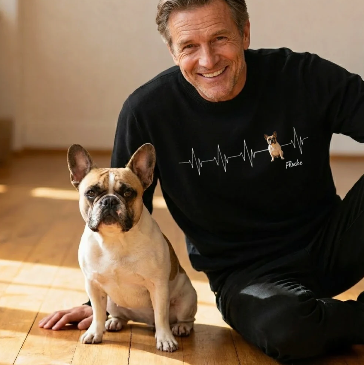 Felpa nera personalizzata con motivo battito cardiaco e foto di cane. Un uomo seduto accanto a un cane.
