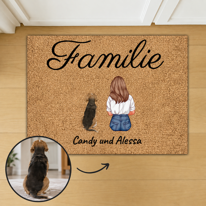 Zerbino in fibra di cocco personalizzato con la parola "Familie" e illustrazioni di una donna e un cane.